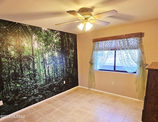 spare room featuring ceiling fan and a textured ceiling