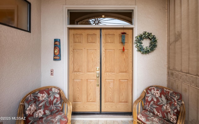 property entrance with stucco siding