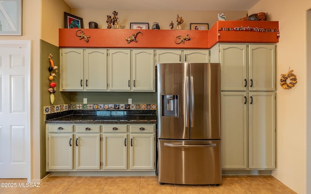 kitchen with stainless steel refrigerator with ice dispenser and light tile patterned floors