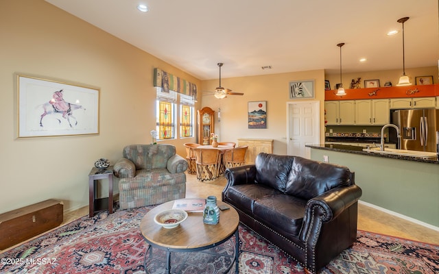 tiled living room featuring sink and ceiling fan