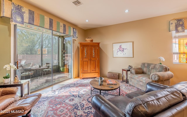 living area featuring recessed lighting and visible vents