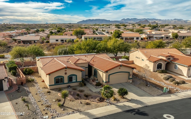 drone / aerial view with a residential view and a mountain view