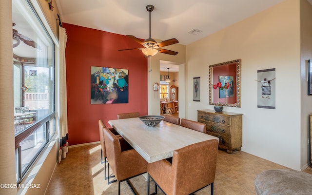 dining room with baseboards, visible vents, light tile patterned floors, and a ceiling fan