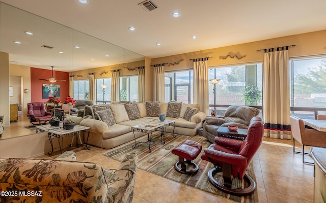 living area featuring recessed lighting, light tile patterned flooring, visible vents, and plenty of natural light