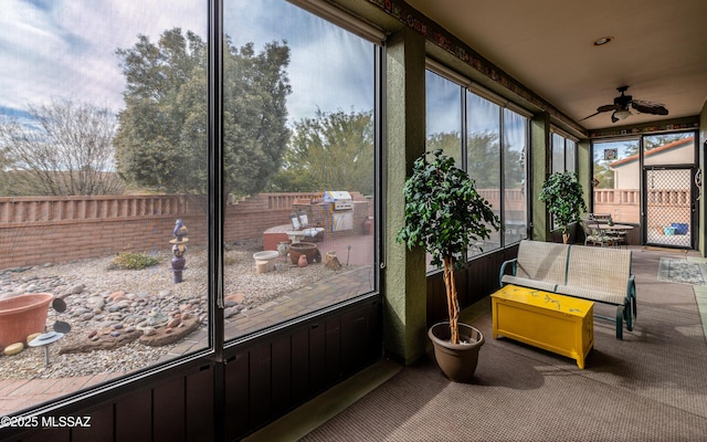sunroom / solarium featuring ceiling fan