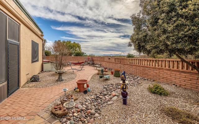view of yard featuring a patio and a fenced backyard