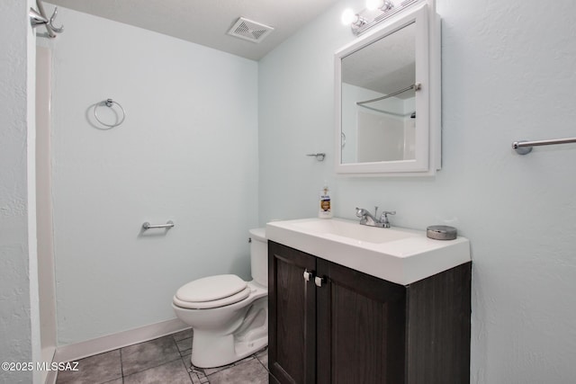 bathroom with toilet, tile patterned flooring, and vanity