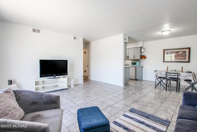 living room with sink and light tile patterned flooring