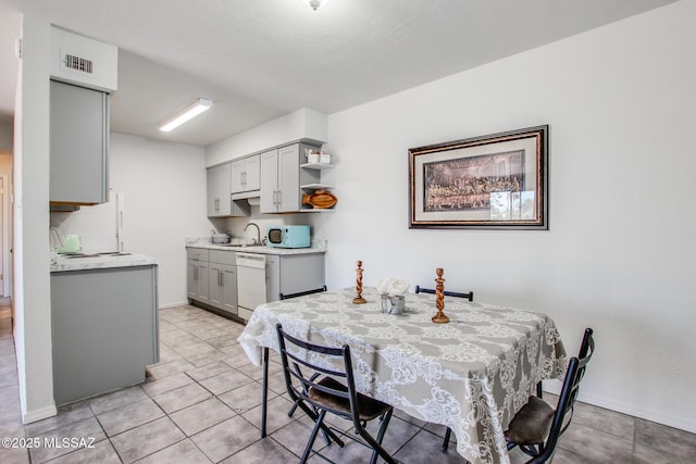 dining area with sink and light tile patterned floors