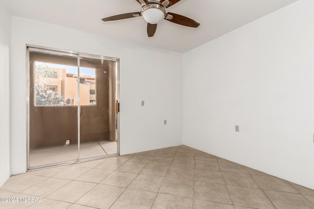 unfurnished room featuring light tile patterned flooring and ceiling fan