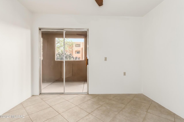 spare room with light tile patterned floors and ceiling fan