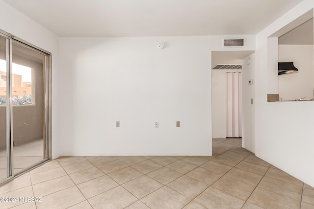 unfurnished room featuring light tile patterned floors