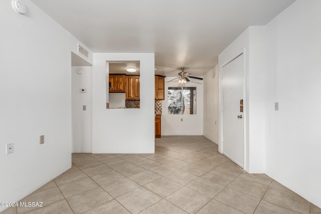 spare room with light tile patterned floors and ceiling fan