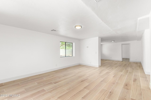 empty room with light hardwood / wood-style floors