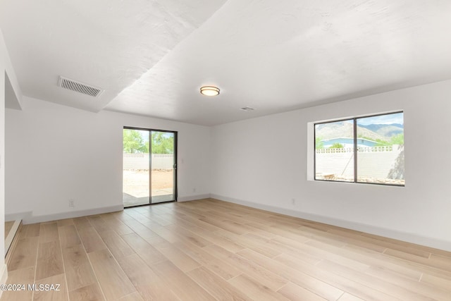 spare room featuring light hardwood / wood-style flooring