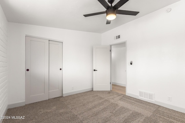 unfurnished bedroom featuring ceiling fan, carpet flooring, and a closet