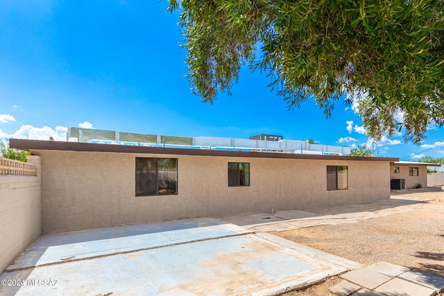 back of house featuring central AC unit and a patio