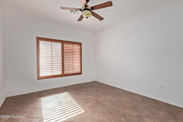 spare room with light tile patterned flooring and ceiling fan