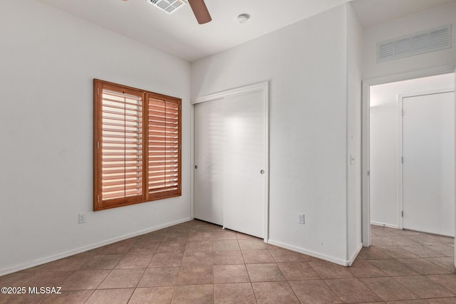 unfurnished bedroom featuring ceiling fan, a closet, and light tile patterned floors