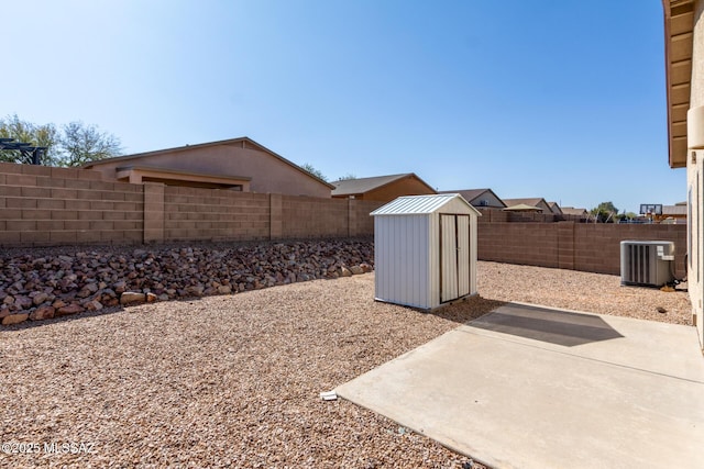 view of yard featuring a storage shed, a patio, and central air condition unit