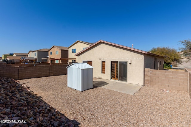 rear view of house featuring a shed and a patio