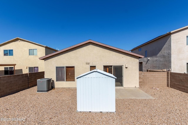 rear view of property featuring central AC and a patio area