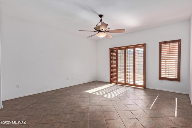 unfurnished room featuring tile patterned floors and ceiling fan