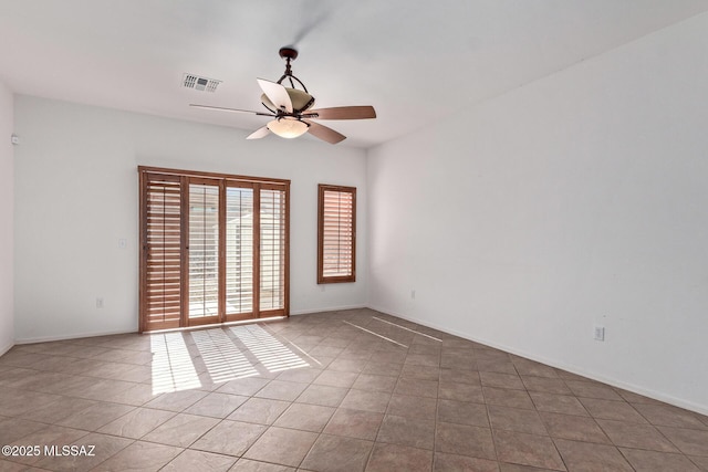 unfurnished room with light tile patterned floors and ceiling fan