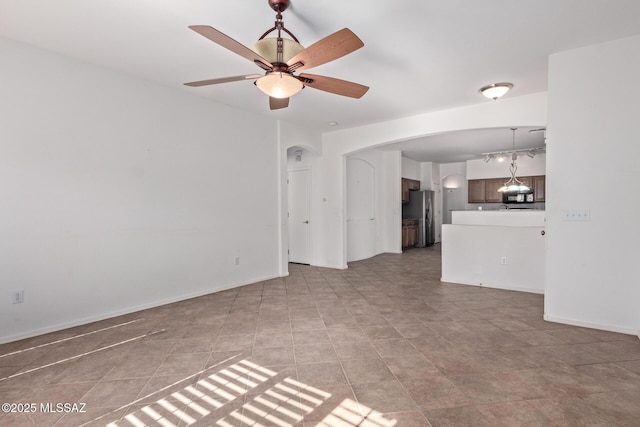 unfurnished living room with ceiling fan