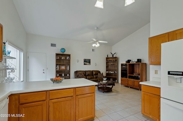 kitchen with lofted ceiling, white appliances, light tile patterned floors, kitchen peninsula, and ceiling fan