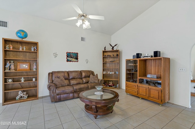 living area with ceiling fan, visible vents, vaulted ceiling, and light tile patterned floors