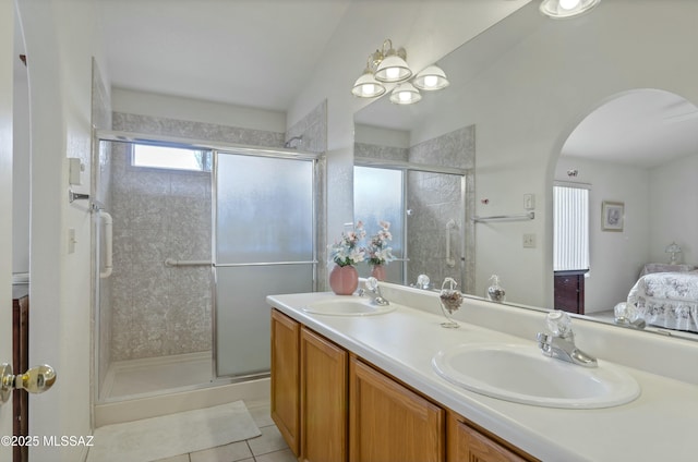 bathroom featuring a sink, a shower stall, and double vanity