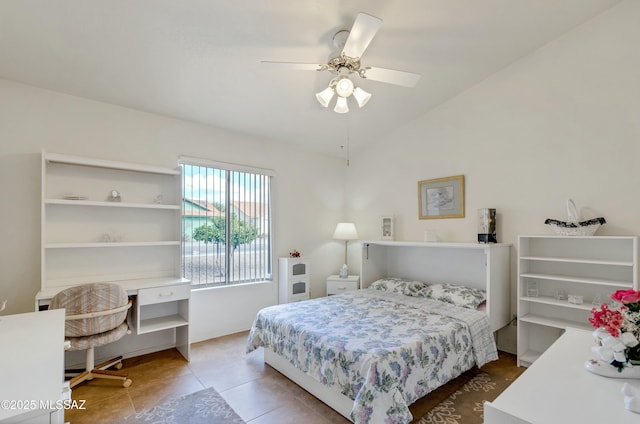 tiled bedroom with lofted ceiling and ceiling fan