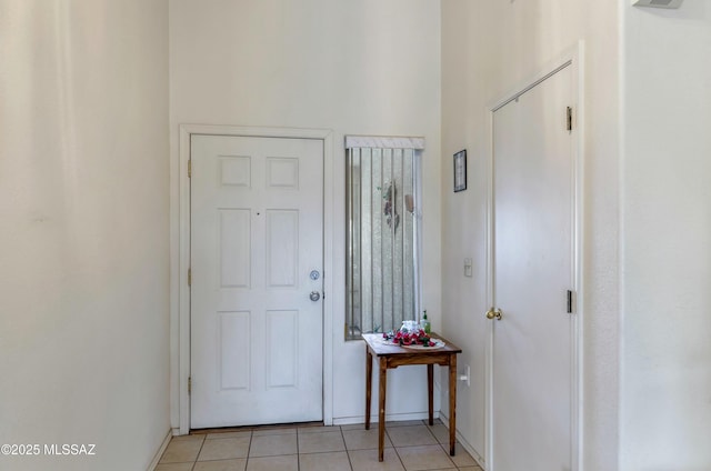 foyer entrance featuring light tile patterned flooring