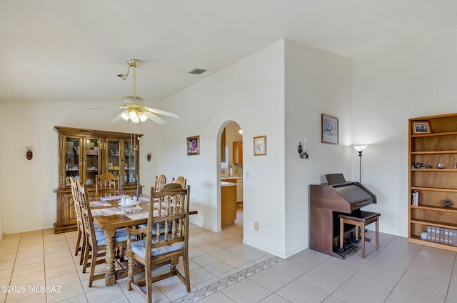 dining room with vaulted ceiling, ceiling fan, and light tile patterned flooring