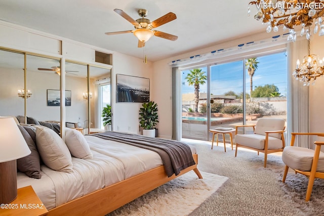 carpeted bedroom featuring multiple closets, access to exterior, and a chandelier