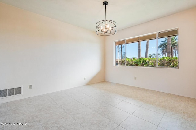 unfurnished room with a chandelier and light tile patterned floors