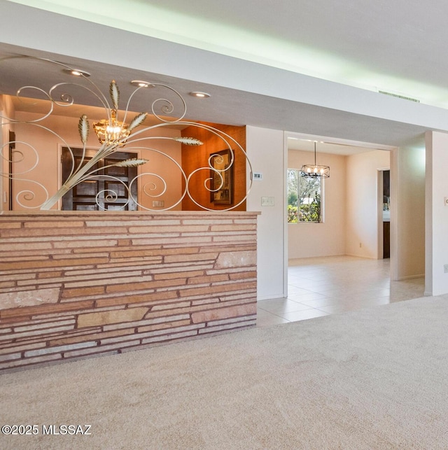 unfurnished living room with carpet floors and a notable chandelier