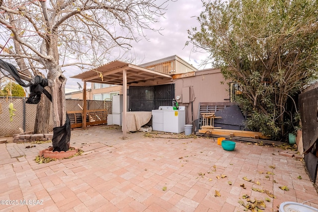 view of patio featuring a pergola and washing machine and dryer