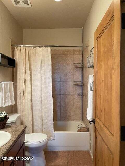 full bathroom featuring shower / bath combination with curtain, vanity, toilet, and tile patterned flooring