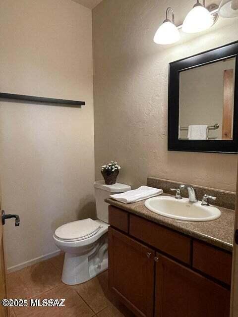 bathroom with vanity, tile patterned floors, and toilet