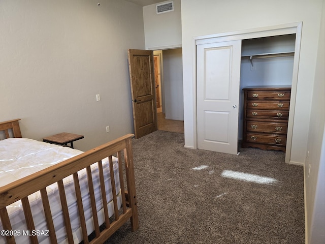 unfurnished bedroom featuring dark colored carpet and a closet