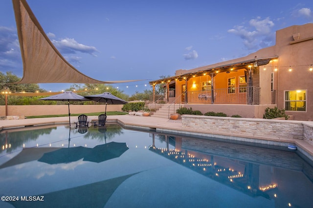 view of pool at dusk