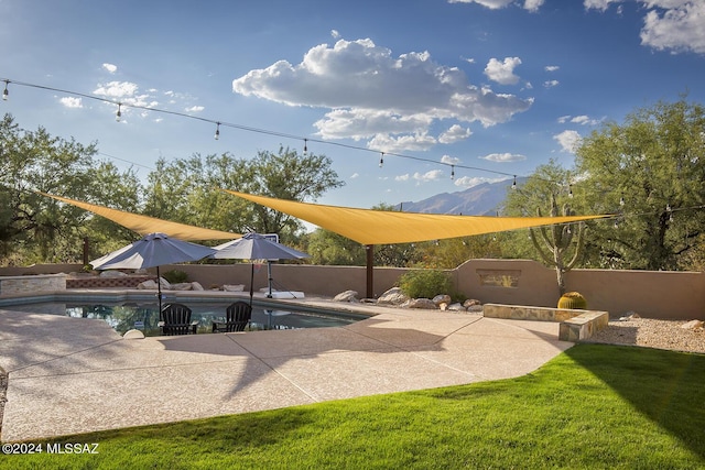 view of swimming pool with a fenced in pool, a lawn, a fenced backyard, and a patio area