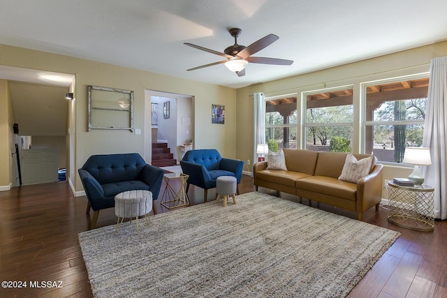 living room featuring dark hardwood / wood-style flooring and ceiling fan