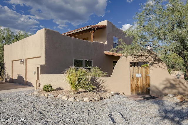 view of property exterior with a garage and stucco siding