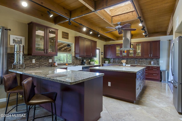 kitchen featuring a kitchen island, backsplash, stainless steel refrigerator, and wood ceiling