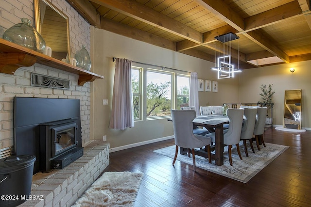 dining space with dark hardwood / wood-style floors, a fireplace, beamed ceiling, a chandelier, and wood ceiling