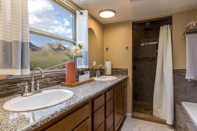 full bathroom featuring tiled shower, visible vents, and a sink