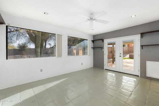 spare room with french doors and ceiling fan